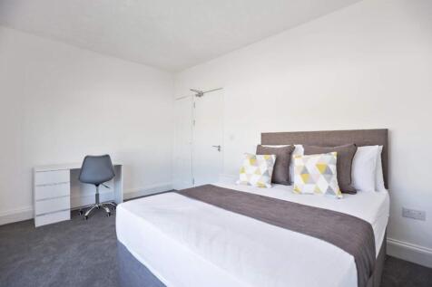 Bright and spacious double bedroom featuring a ...