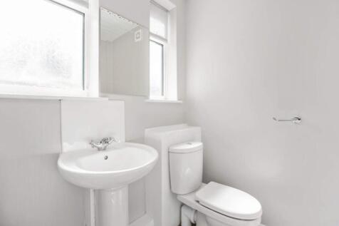 A bright and modern bathroom featuring a sleek ...