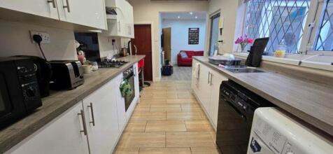 A modern and spacious kitchen featuring ample s...