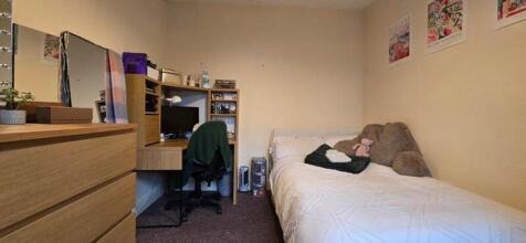 A cozy and inviting double bedroom with a study...