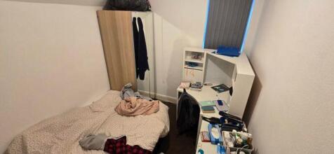A cozy double bedroom with adequate space for s...
