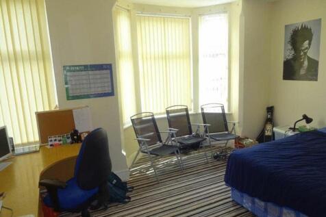 A spacious and well-lit double bedroom featurin...