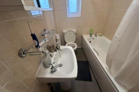A tidy and functional bathroom featuring a bath...