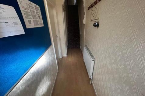 A tidy and well-maintained hallway with a warm ...