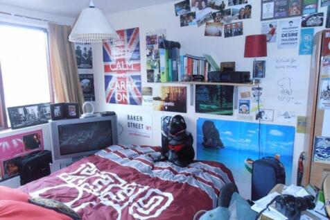 A cozy double bedroom adorned with personal tou...