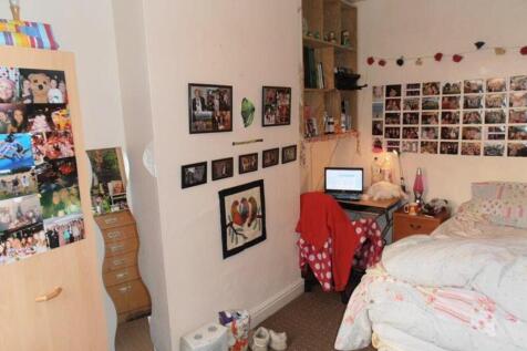 A cozy double bedroom decorated with personal p...