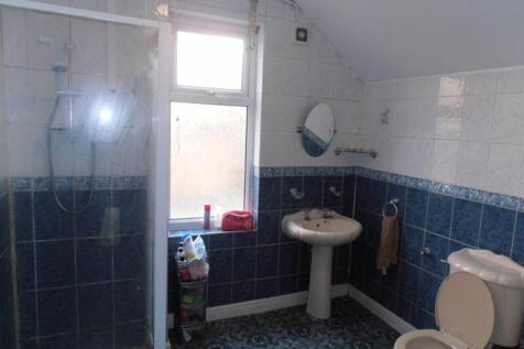 A spacious bathroom featuring a modern shower a...