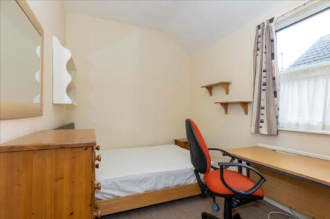 This cozy double bedroom features a comfortable...