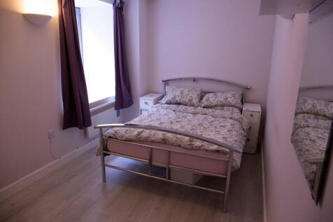 This cozy double bedroom features a comfortable...