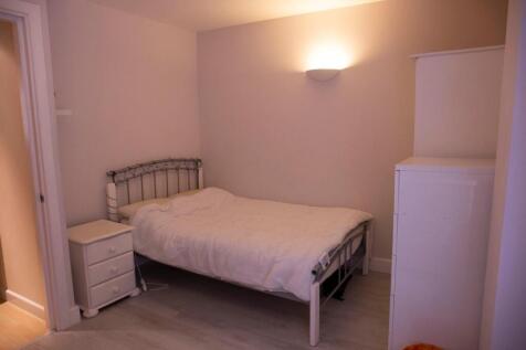 Cozy double bedroom featuring a comfortable bed...