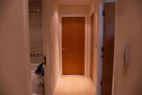 A well-maintained hallway featuring warm lighti...