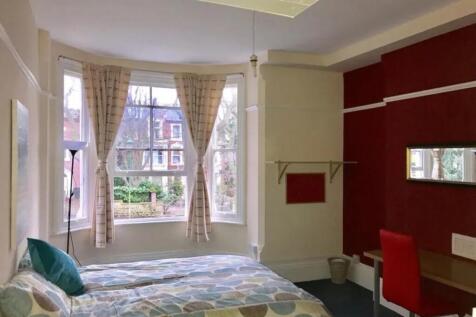 Bright and spacious double bedroom featuring la...