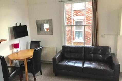 A cozy living room featuring a comfortable leat...