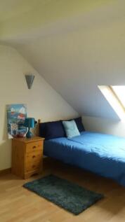Cozy double bedroom featuring a comfortable blu...