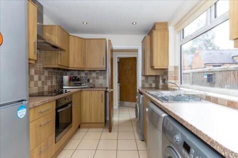This modern kitchen features ample storage with...