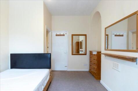 Spacious double bedroom featuring a minimalist ...