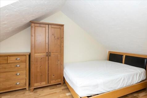 This charming double bedroom features a cozy wo...