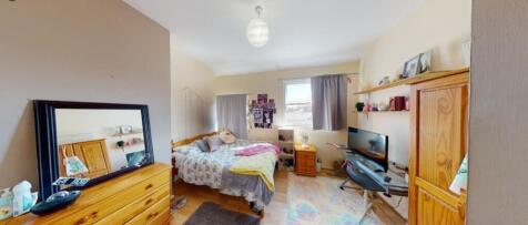 Spacious double bedroom featuring ample natural...