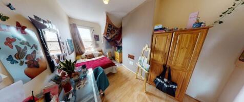This charming double bedroom features a cozy at...