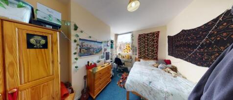 A cozy double bedroom featuring ample natural l...