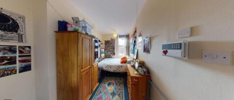 This cozy double bedroom features vibrant decor...