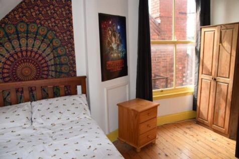 A charming double bedroom featuring ample natur...