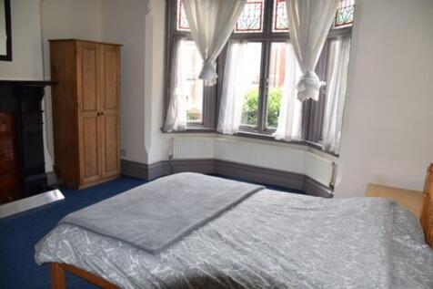 Spacious double bedroom featuring large windows...