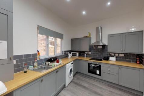 A modern and spacious kitchen equipped with ess...
