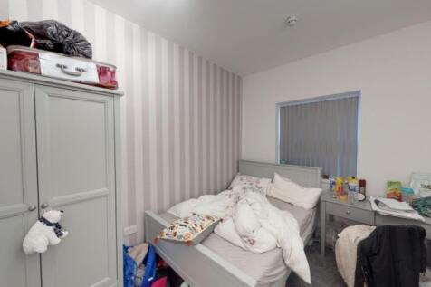 A cozy double bedroom with a comfortable bed an...