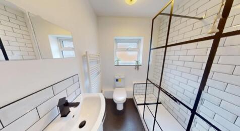 A spacious and modern bathroom featuring a styl...