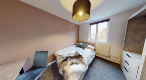 A bright and inviting double bedroom featuring ...