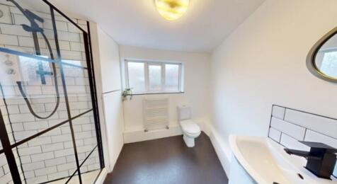 A bright and modern bathroom featuring a spacio...