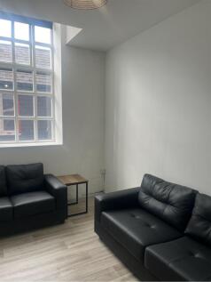 Bright and inviting living room featuring styli...