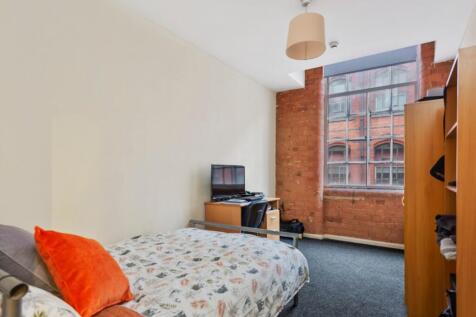 Spacious double bedroom featuring large windows...