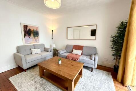 A bright and inviting large modern living room ...