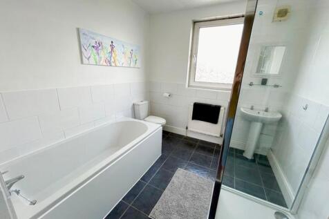 A spacious and bright large bathroom featuring ...