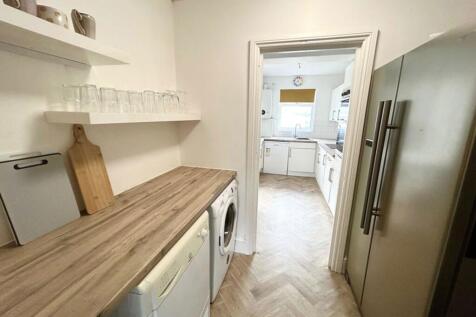 A modern kitchenette featuring a clean and tidy...