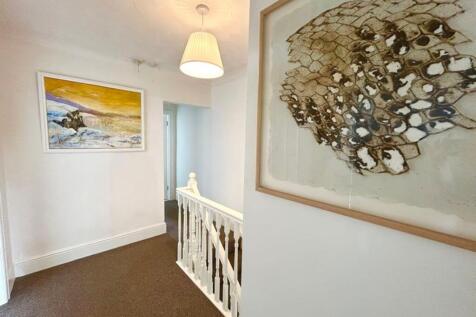 A bright and clean hallway featuring artistic d...