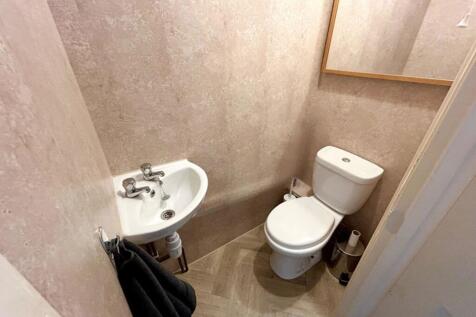 A tidy and functional single toilet with modern...
