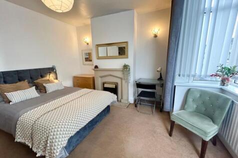 A spacious and inviting double bedroom featurin...