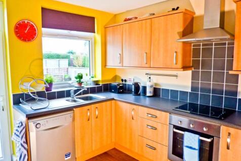 A bright and modern kitchen with ample storage ...