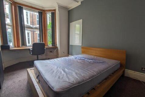 A bright and spacious double bedroom with large...