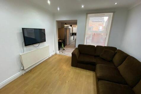 A bright and inviting living room with a cozy s...