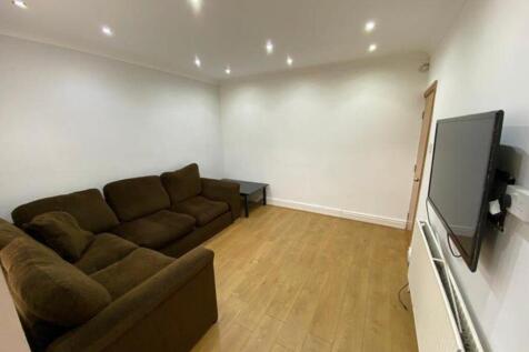 A spacious and tidy living room featuring moder...