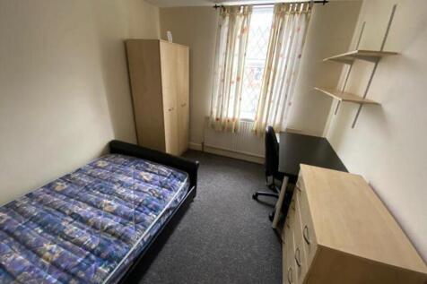 A spacious and well-lit double bedroom featurin...