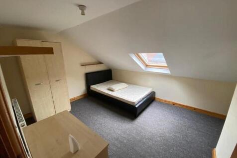 A spacious and well-lit double bedroom perfect ...