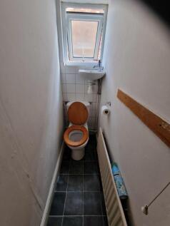 A clean and functional single toilet with good ...
