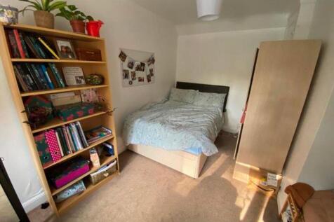 A bright and inviting double bedroom with ample...