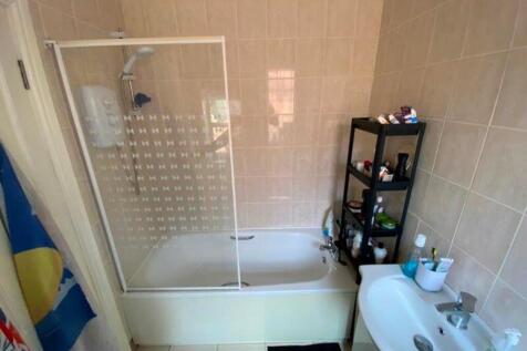 A well-maintained bathroom featuring a bath and...