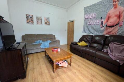 A spacious and inviting large living room, perf...